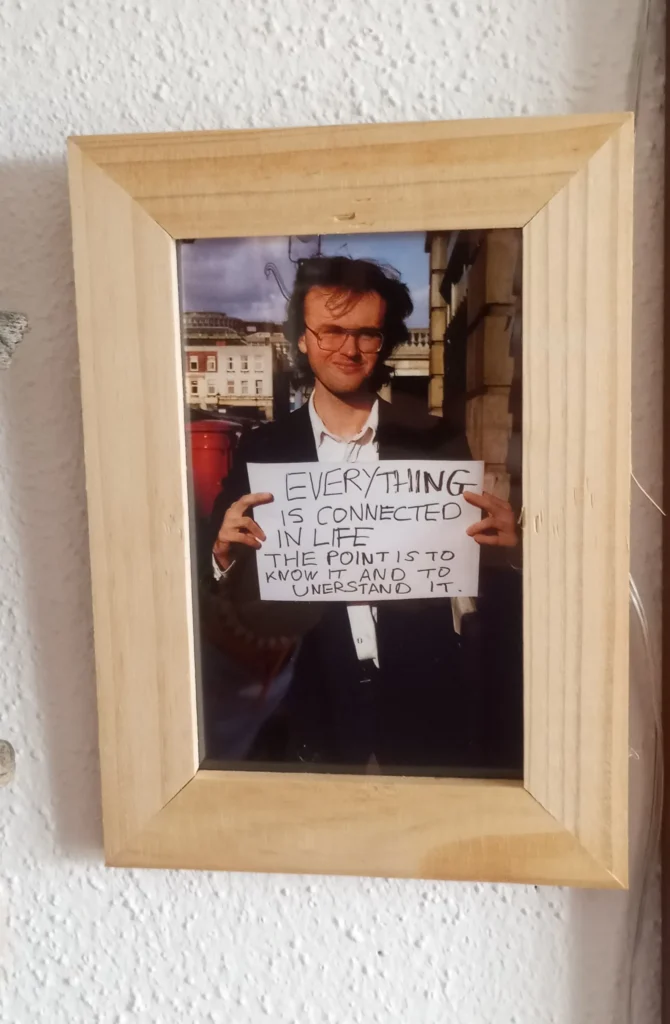 A young man holding a sign indirectly states that feeling grateful is unnecessary