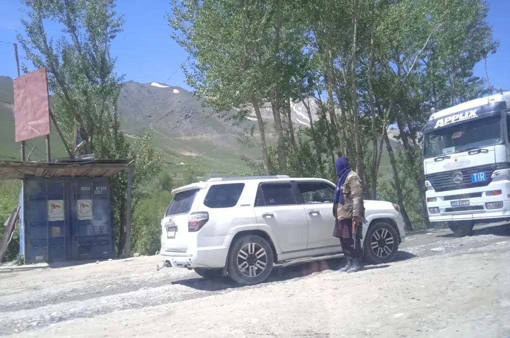 Taliban checking a white car in Afghanistan